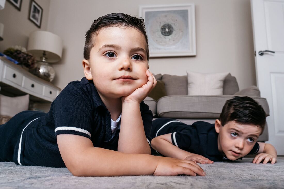 Two brother chilling on the living room floor during a relaxed family photography session in Derry, Northern Ireland by Patrick Duddy Photography