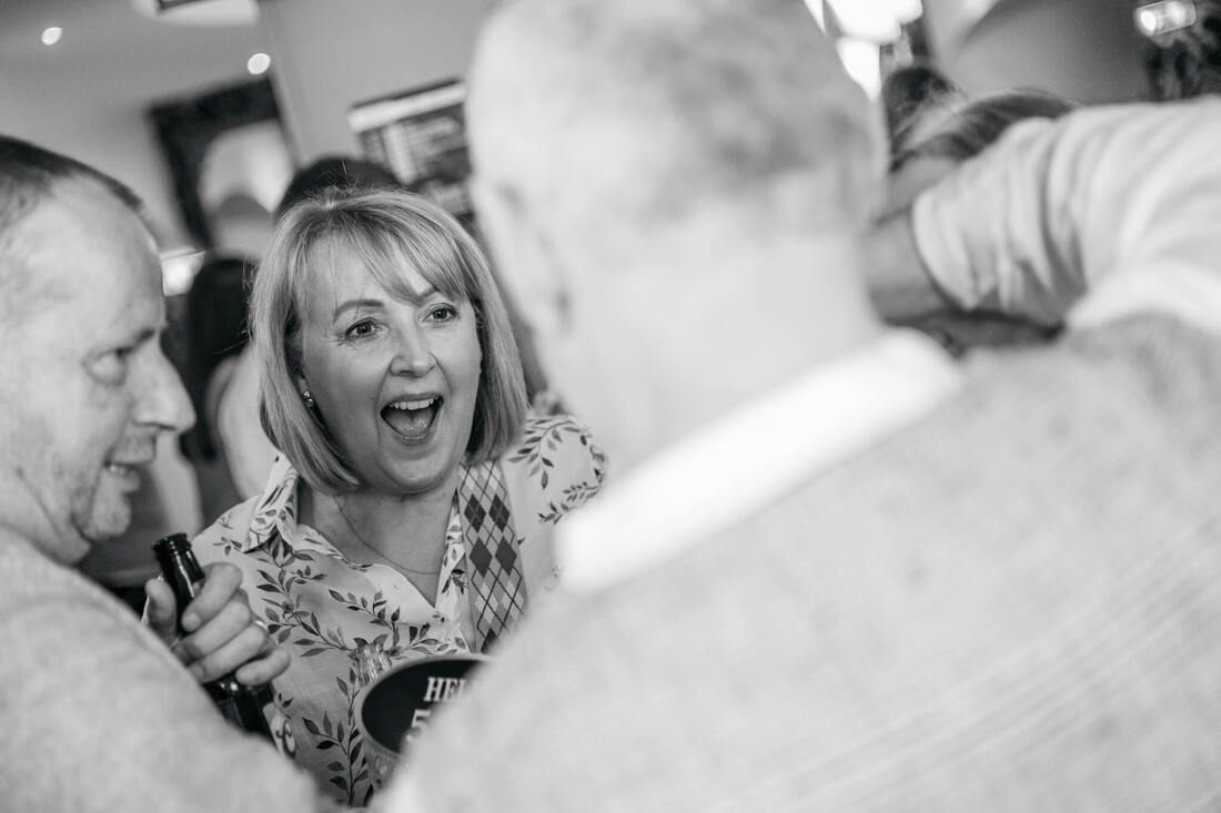 Party goers laughing in the Kiwi Bar Portrush as captured by Patrick Duddy Photography