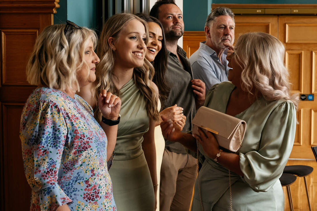 Patrick Duddy captures bride, groom, and family sharing heartfelt moments and hugs after the wedding ceremony at Derry Guildhall