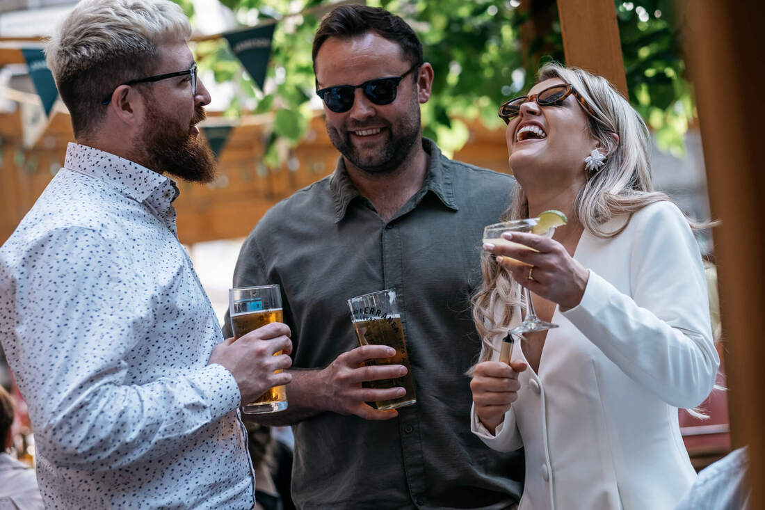 Springtime celebration: Family and friends relishing drinks in the sunshine, immersed in the craic during the Derry Wedding Civil Ceremony Celebrations at Guildhouse Taphouse Derry - captured by Patrick Duddy